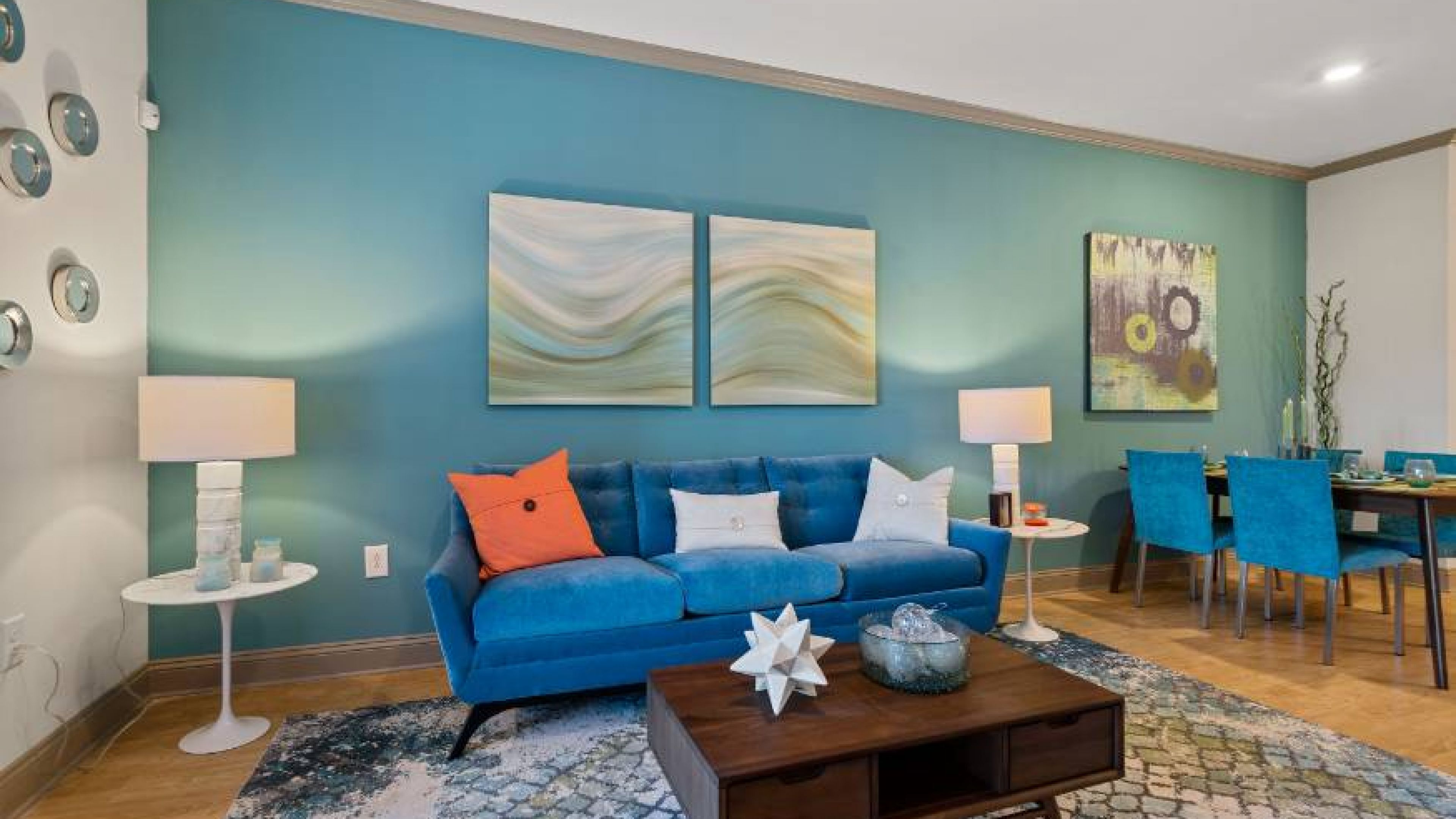 Hawthorne at Southside apartment with a cozy living room with soothing blue walls and a matching blue couch, creating a serene ambiance